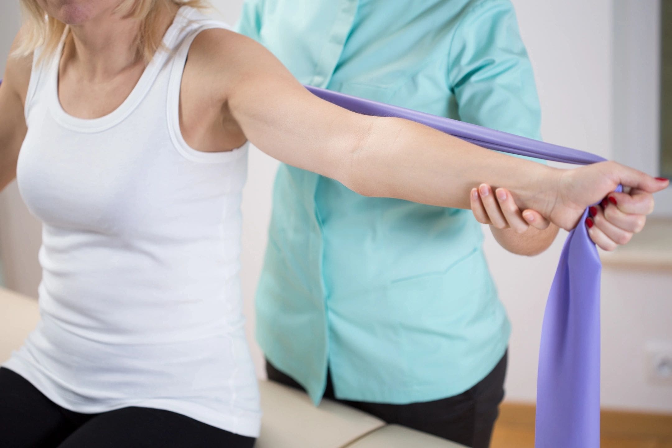 Woman doing arm exercises with resistance band.