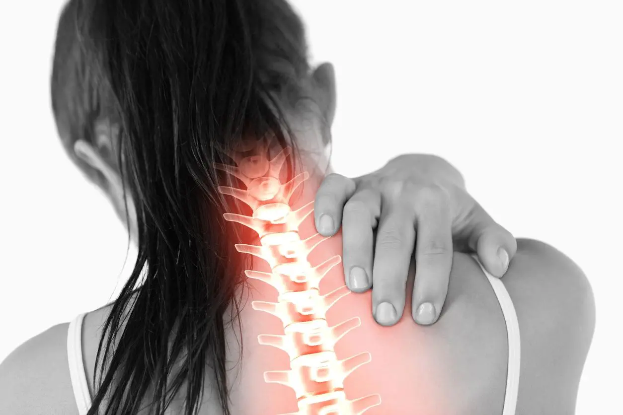 Woman with neck pain and highlighted spine.