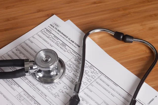 Stethoscope on a health insurance claim form.