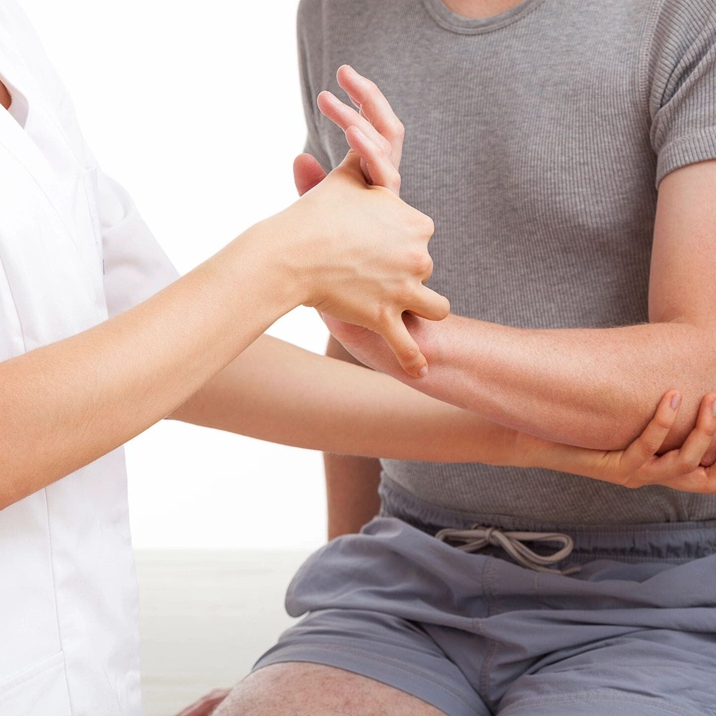 Doctor examining patient's elbow.