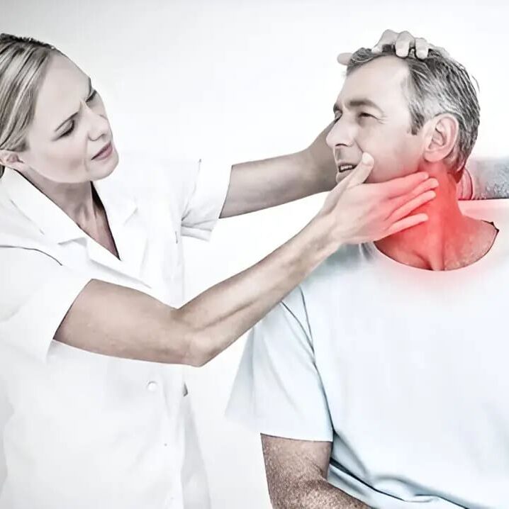 Doctor examining patient's swollen neck.